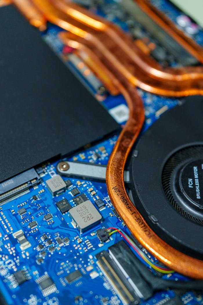 who-we-are Detailed view of a computer motherboard showcasing heat pipes and internal circuitry.